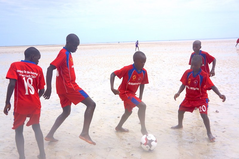 Kids playing football at the beach of Mombasa