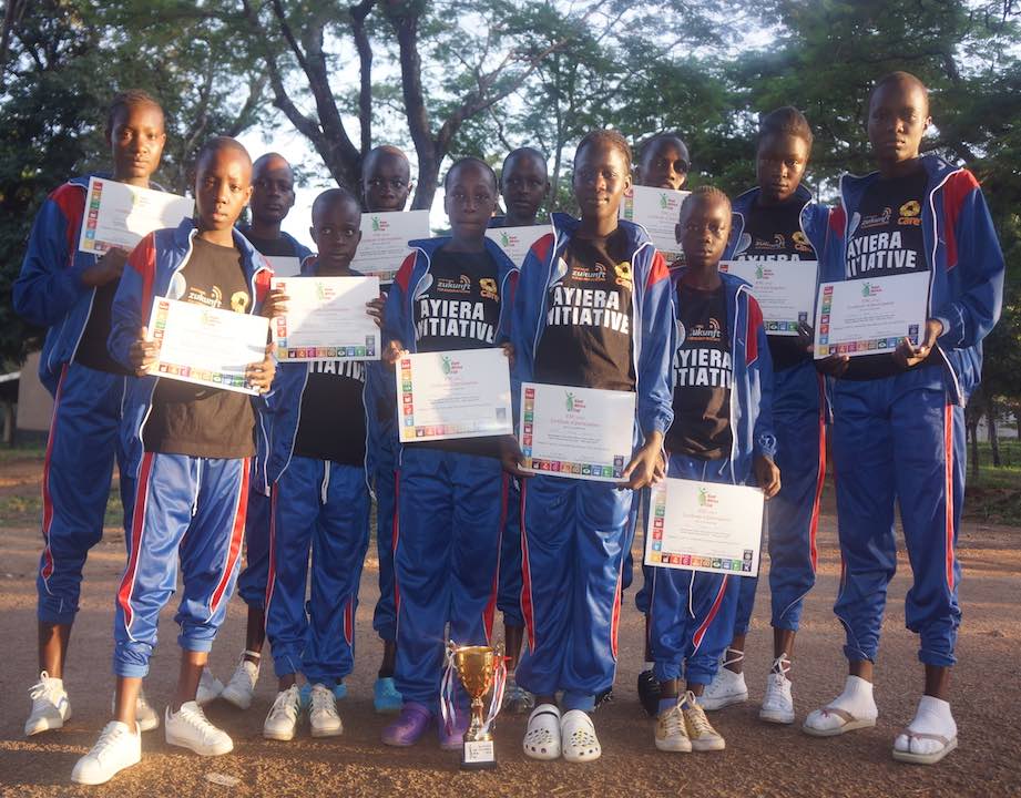 Ayiera Initiative participants with a trophy and certificates they were awarded after emerging the third best team in East Africa Cup 2018