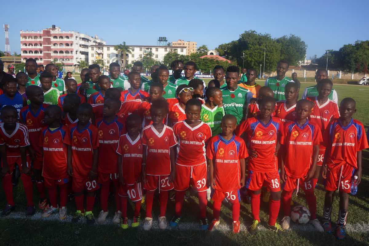 Ayiera Initiative participants pose for a photo with Gor Mahia players after the end of a KPL match