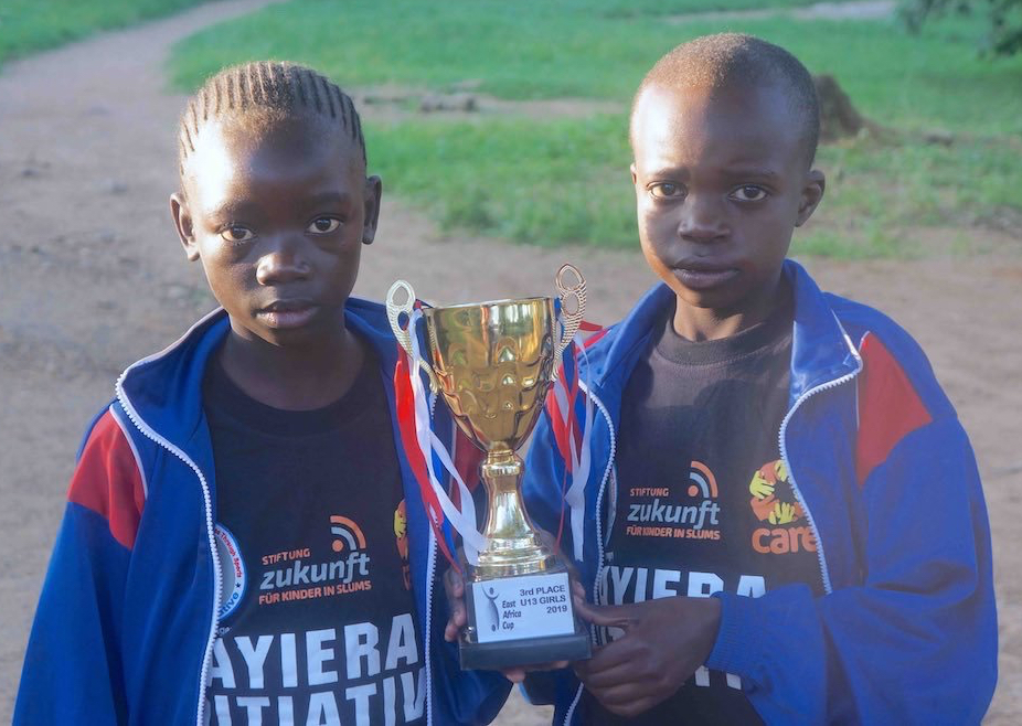 Ayiera Initiative participants displaying a trophy they won as the third best team in the East Africa Cup 2019 edition held in Moshi, Tanzania