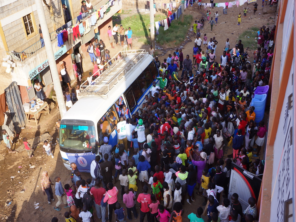 Community members and children turn up in large numbers to welcome the children back from the East Africa Cup tournament