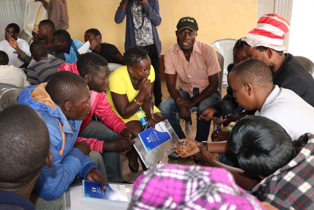 Youths engaging in discussions on how to create meaningful impact in Korogocho in entrepreneurship and small income-generating activities