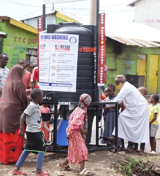 Slum Community members using a free hand washing station by Ayiera Initiative to fight Corona in Korogocho slum