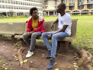 Tabitha, a university scholarship beneficiary engages with AI staff