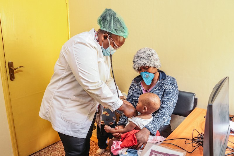 A child receiving medical checkup at the Korogocho Health Clinic